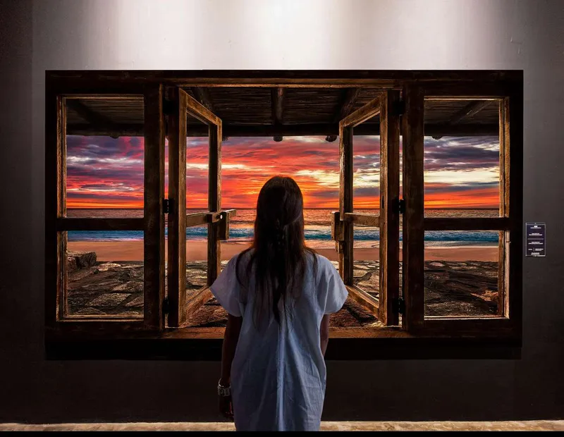 Visitor surrounded by projection-mapped nature scenes at Mystika, immersive museums in Mexico City